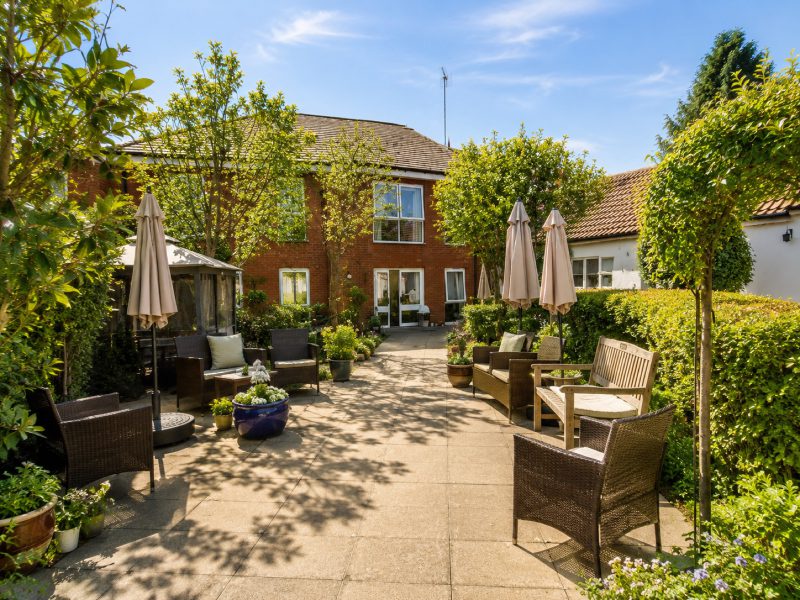 A garden seating area at Burleigh House care home, Baldock